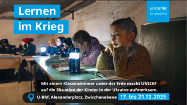 Mehrere Kinder sitzen in einem dunklen Kellerraum, lesen und arbeiten mit Lampen aufmerksam